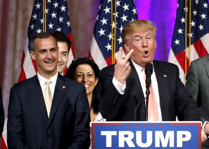Donald Trump's campaign manager Corey Lewandowski (L) looks on as Trump speaks about the results of the Florida, Ohio, North Carolina, Illinois and Missouri primary elections during a news conference held at his Mar-A-Lago Club in Palm Beach, Florida, U.S. on March 15, 2016.