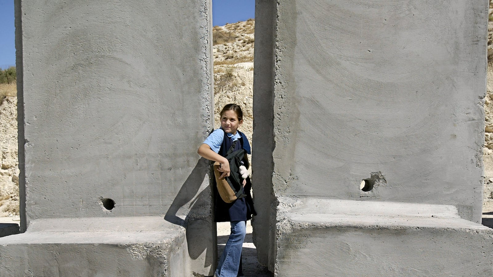 articles/2013/01/22/across-the-wall-little-interest-in-israeli-race/girl-barrier-openz_ocofbx