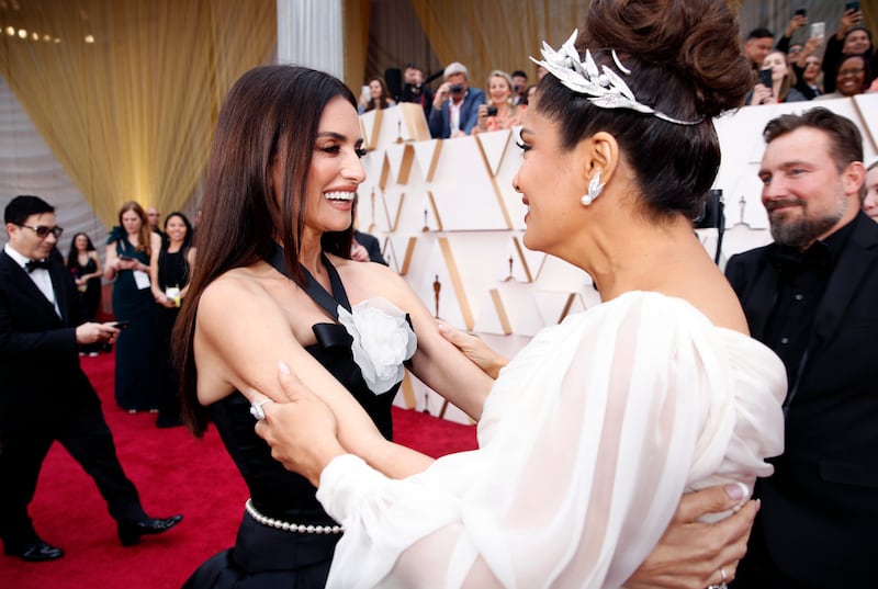 Salma Hayek and Penelope Cruz embrace on the red carpet during the Oscars arrivals at the 92nd Academy Awards in Hollywood, Los Angeles, California, U.S., February 9, 2020.