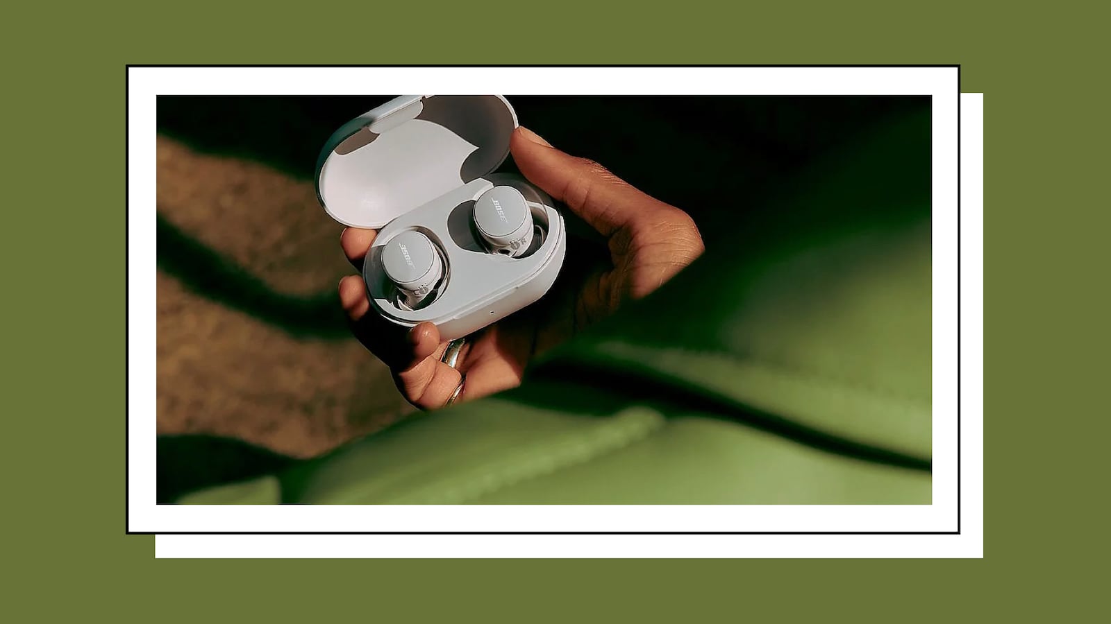 Hand holding a pair of Bose wireless bluetooth earbuds, available at QVC