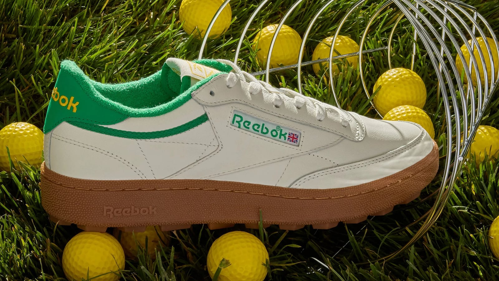 Reebok Men's Club C Golf Shoes next to a group of yellow golf balls.
