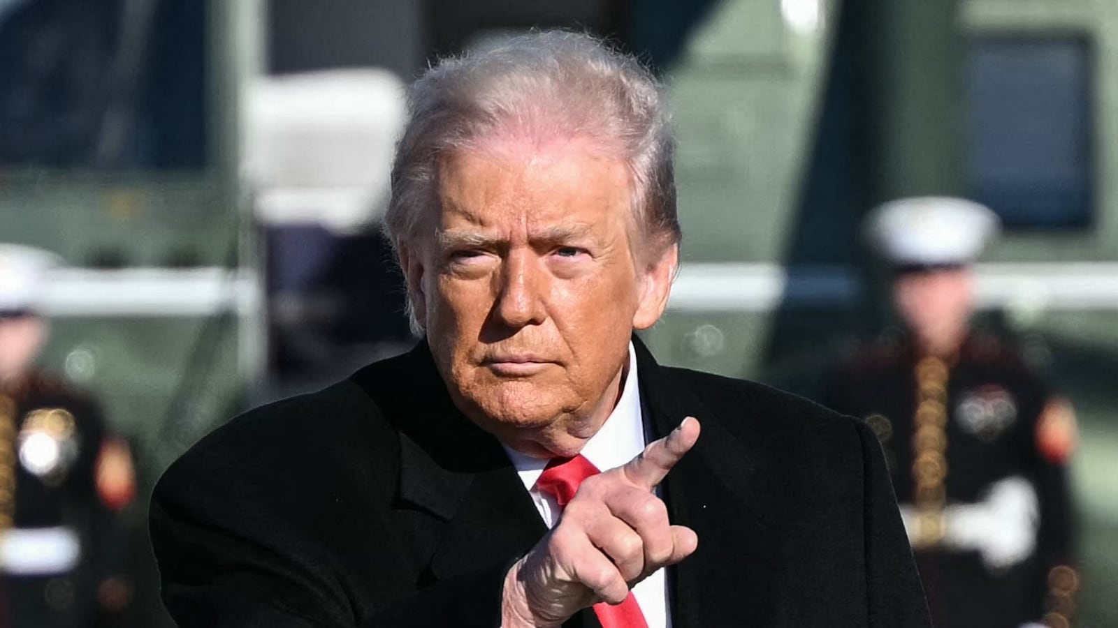 US President Donald Trump gestures as he walks to board Air Force One at Joint Base Andrews, Maryland on January 13, 2026.
