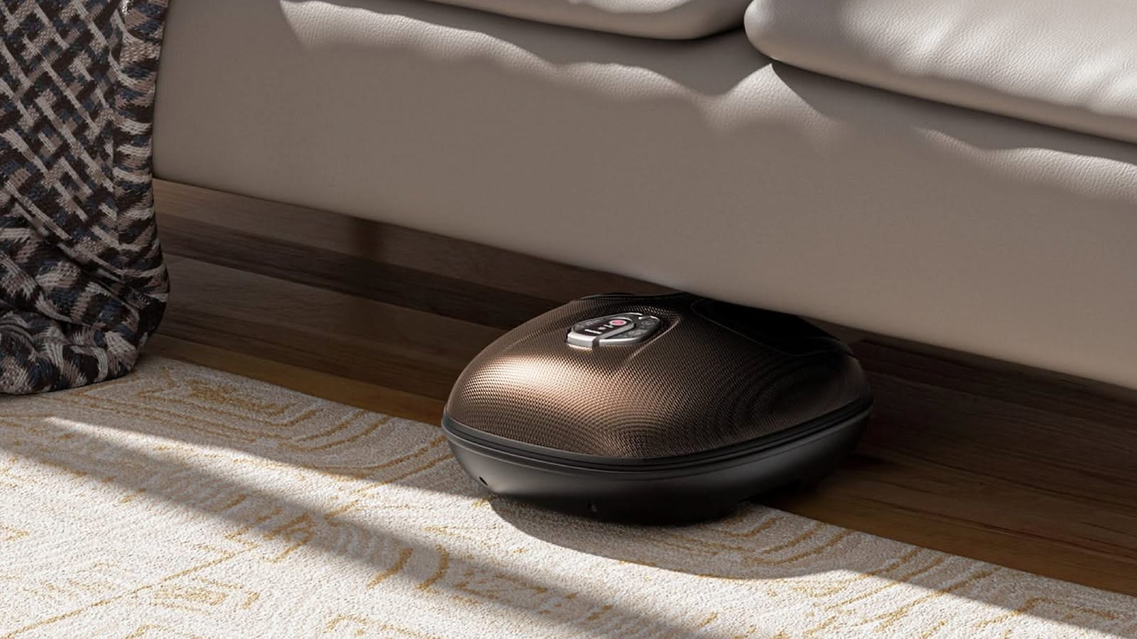 RENPHO Shiatsu Foot Massager stored under a couch on a hardwood floor next to a patterned area rug