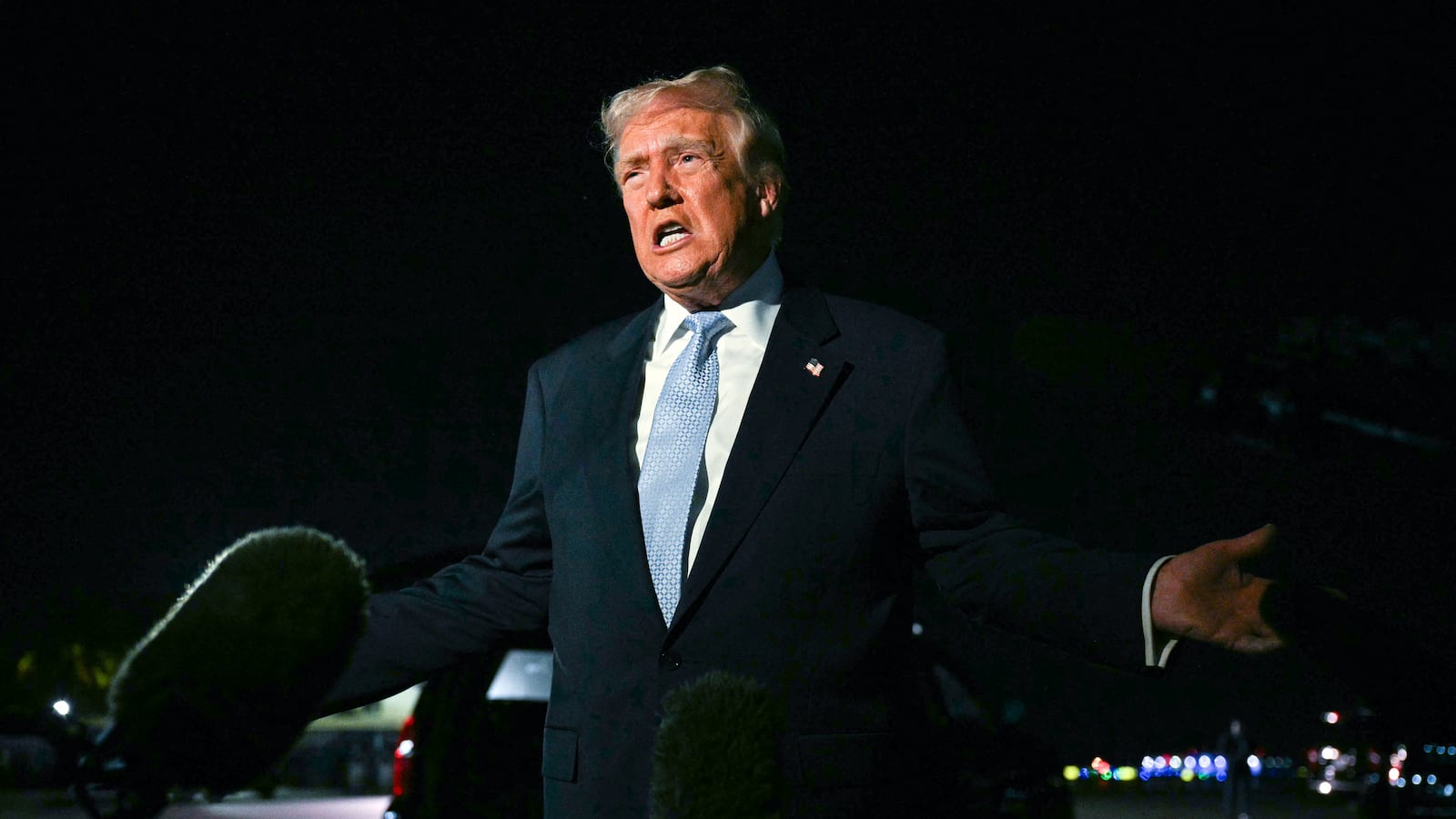 US President Donald Trump speaks with reporters before boarding Air Force One as he departs Palm Beach International Airport in West Palm Beach, Florida, on November 16, 2025. Trump is returning to the White House after spending the weekend at his Mar-a-Lago, Florida, residence. (Photo by Jim WATSON / AFP) (Photo by JIM WATSON/AFP via Getty Images)