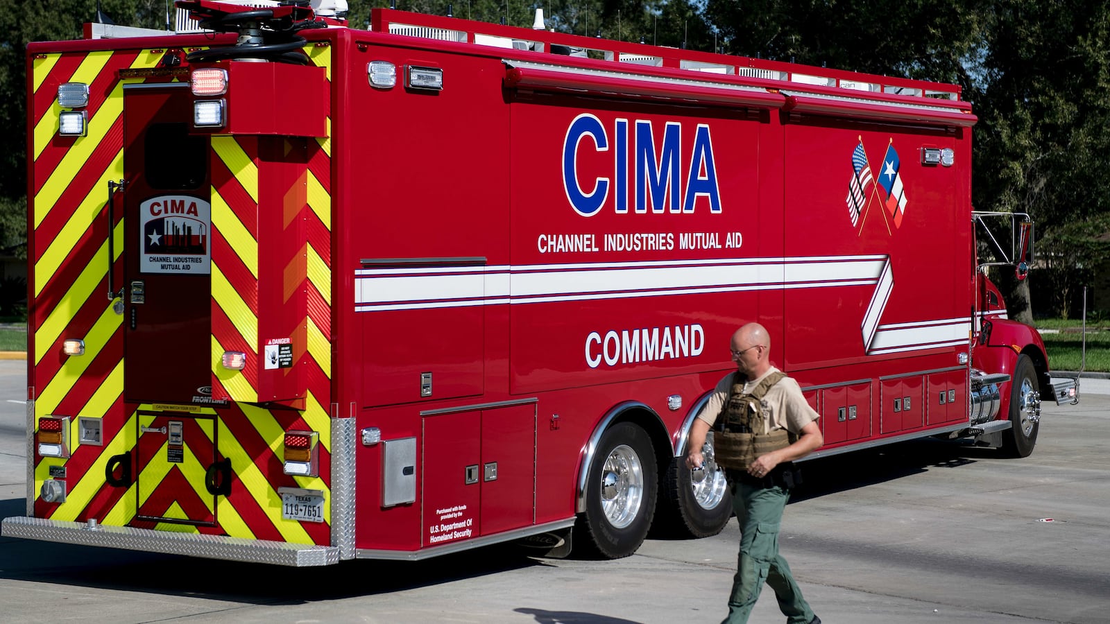 A Harris County Sheriff walks by a Channel Industries Mutual Aid firetruck at the Crosby volunteer fire department after a chemical plant operated by the Arkema Group had an explosion during the aftermath of Hurricane Harvey
