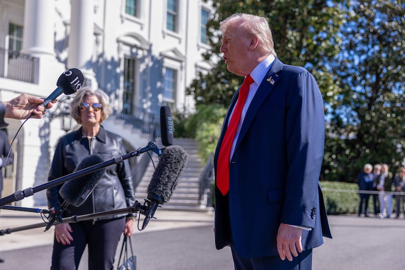 White House Chief of Staff Susie Wiles listens as U.S. President Donald Trump talks to the media.