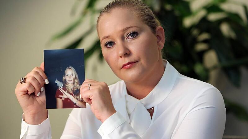 Virginia Roberts Giuffre, with a photo of herself as a teen, when she says she was abused by Jeffrey Epstein, Ghislaine Maxwell and Prince Andrew, among others. (Emily Michot/Miami Herald/Tribune News Service via Getty Images)