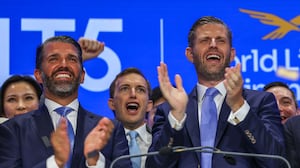 Zach Witkoff flanked by Eric Trump and Donald Trump Jr. in August.