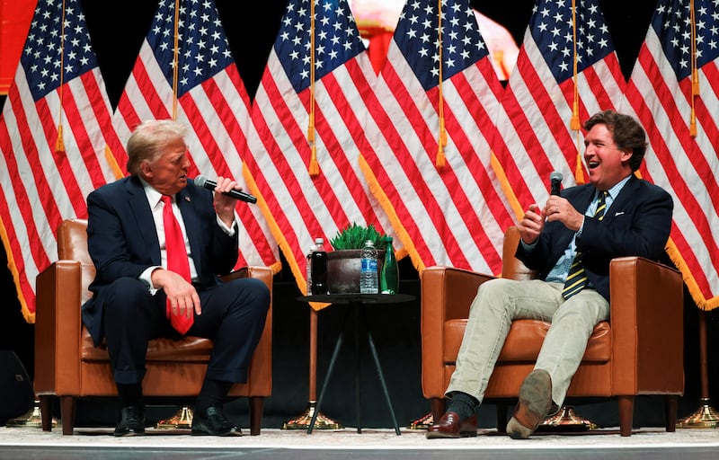 Republican presidential nominee and former U.S. President Donald Trump participates in a fireside chat with Tucker Carlson at 'Tucker Carlson Live on Tour' at Desert Diamond Arena, in Glendale, Arizona, U.S. October 31, 2024. REUTERS/Brendan McDermid
