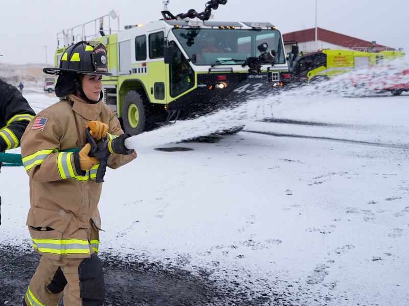 Kristi Noem wears full firefighting gear for an exercise with the U.S. Coast Guard.