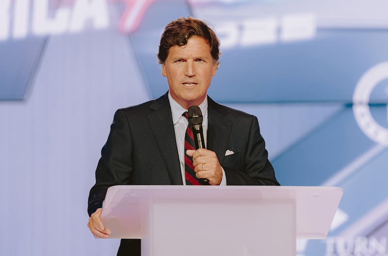 Conservative political commentator and podcast host Tucker Carlson speaks at Turning Point's annual AmericaFest conference, in remembrance of late right-wing political activist Charlie Kirk, in Phoenix, Arizona on December 18, 2025. Kirk was shot dead on a Utah college campus in September, sparking a wave of grief among conservatives, and threats of a clampdown on the "radical left" from President Donald Trump. (Photo by Olivier Touron / AFP via Getty Images)