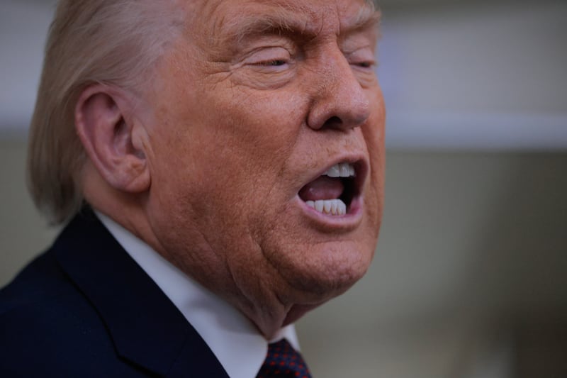 U.S. President Donald Trump speaks to reporters on board Air Force One while flying in between Ireland and Washington as he returns from the World Economic Forum on January 22, 2026 at Joint Base Andrews, Maryland.