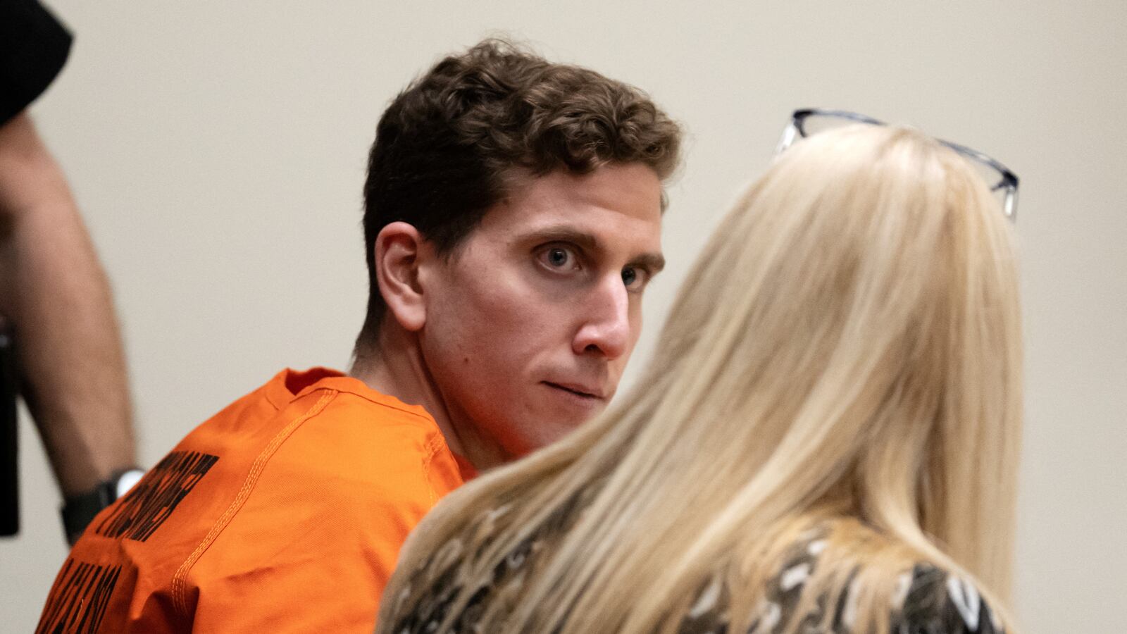 Cops in Pennsylvania barged into Bryan Kohberger's family home to find him in the kitchen, wearing latex gloves and placing his personal trash into Ziploc baggies, prosecutors say.