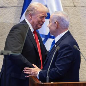 President Donald Trump shakes hands and speaks with Israeli Prime Minister Benjamin Netanyahu at the Knesset, Israel's parliament, on the day of Trump's address on October 13, 2025 in Jerusalem.