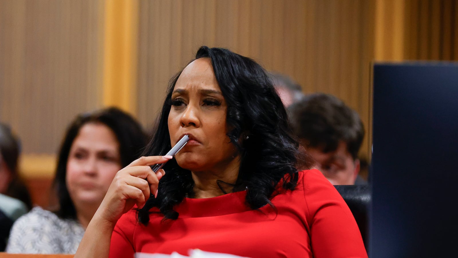 A photo of Fulton County DA Fani Willis sitting in court.