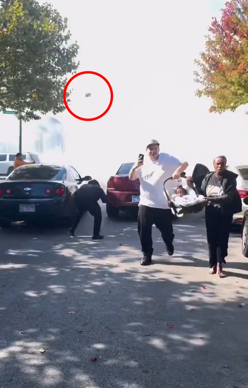 A couple who had been stuck in traffic flees a cloud of tear gas on foot with their baby in a car seat on Oct. 14, 2025.