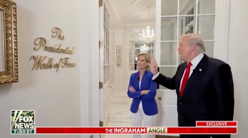 Donald Trump shows off the Presidential Walk of Fame sign.