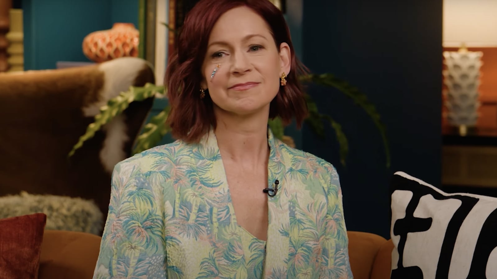 Actress Carrie Preston opens up about reason why she is sporting a bejeweled face on the Busy This Week podcast.
