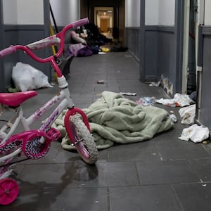 A pink bicycle, diapers, and clothing are scattered about the second floor hallway following a raid by U.S. Immigration and Customs Enforcement agents the previous week at 7500 S. South Shore Drive in Chicago, on Oct. 6, 2025.