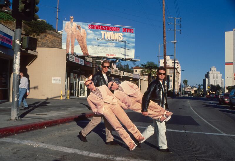 Writers William Davis and William Osborne, who wrote the hit film 'Twins,' carry life size cutouts of the two actors on Hollywood's Sunset Boulevard in 1989.