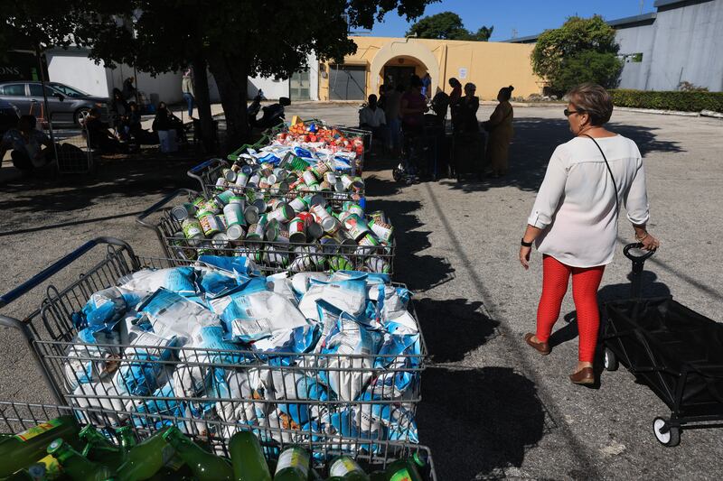 People receive groceries in Flordia from the Curley's House Food Bank days before the Supplemental Nutrition Assistance Program (SNAP) benefits may expire