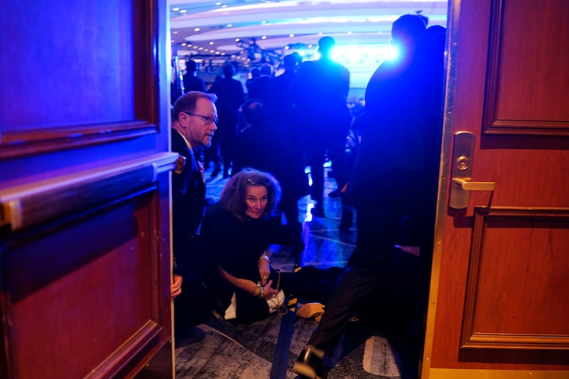 People take cover after an incident at the annual White House Correspondents Association Dinner April 25, 2026 in Washington, DC. According to reports, President Donald Trump, along with other government officials, were evacuated from the Washington Hilton after what sounded like gun fire.