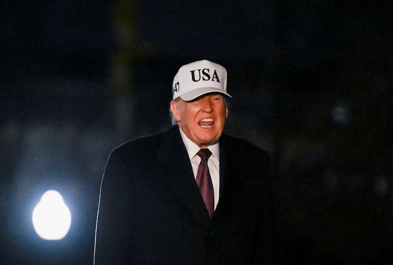 Donald Trump reacts while walking after arriving on the South Lawn aboard Marine One, at the White House in Washington, D.C., U.S., January 11, 2026.