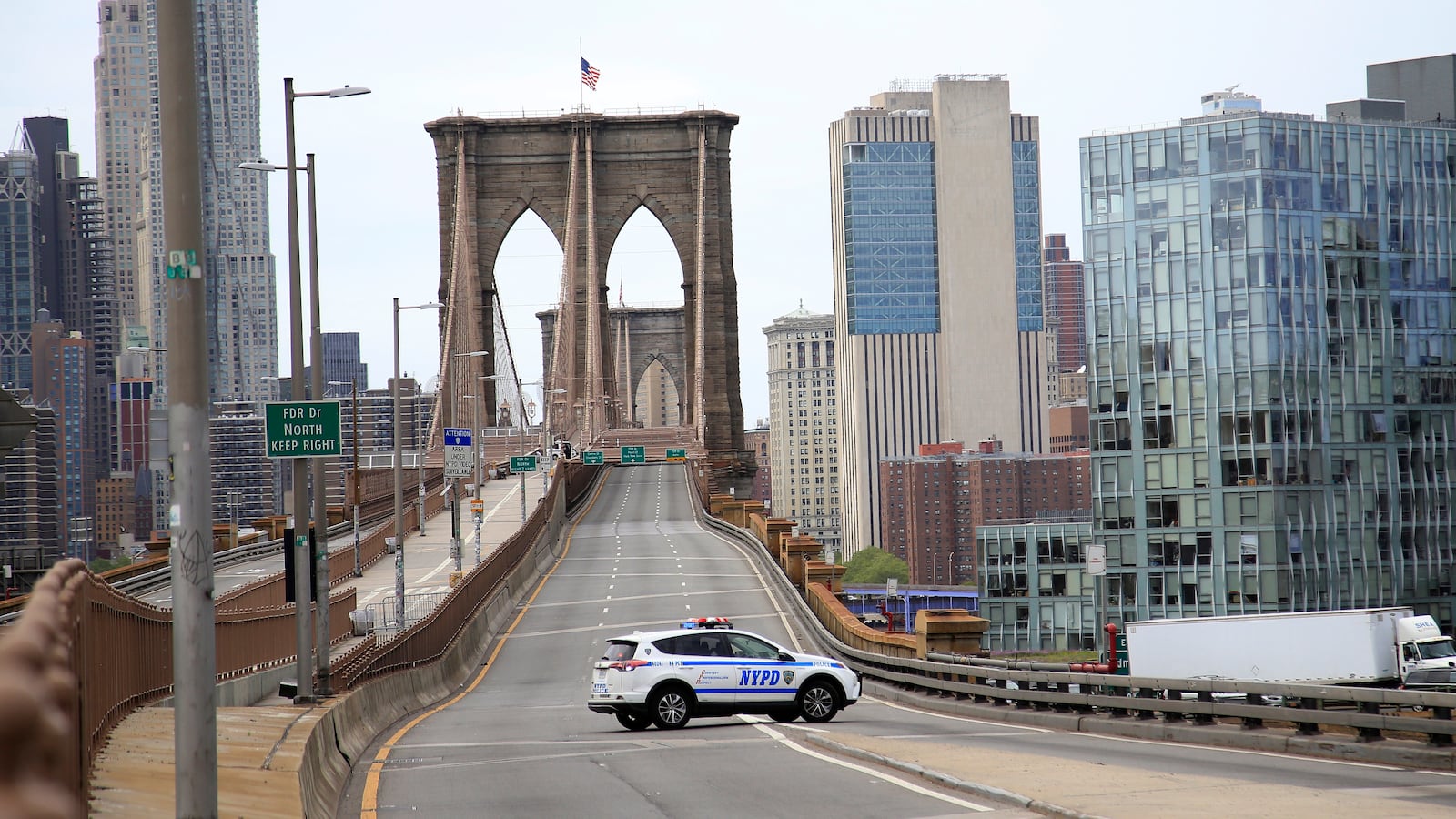 An NYPD Vehicle blocks the entrance to the Brooklyn Bridge after a despondent man climbed to the top of the Manhattan stanchion of the bridge May 22, 2020 in the Dumbo neighborhood of the Brooklyn borough of New York City.