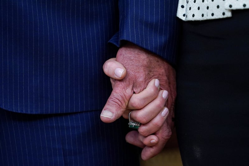 Robert F. Kennedy Jr. holds the hand of his wife Cheryl Hines, on the day Kennedy is sworn in as secretary of Health and Human Service in Washington, D.C., U.S., February 13, 2025.
