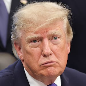 Donald Trump answers questions from reporters during an announcement in the Oval Office at the White House.