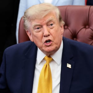 U.S. President Donald Trump answers questions from the media after signing an executive order establishing the President's Military Spouse Commission to be chaired by Jennifer Rauchet, wife of Secretary of Defense Pete Hegseth, in the Oval Office at the White House in Washington, D.C., U.S., August 3, 2026.