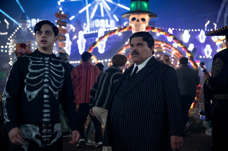 Isaac Ordonez as Pugsley Addams and Luis Guzmán as Gomez Addams.