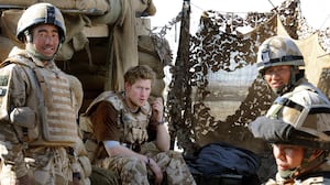 Prince Harry sits with a group of soldiers while on duty on January 2, 2008 in Helmand province, Southern Afghanistan.