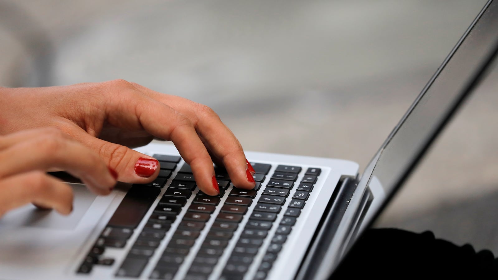 A person types on a laptop computer.
