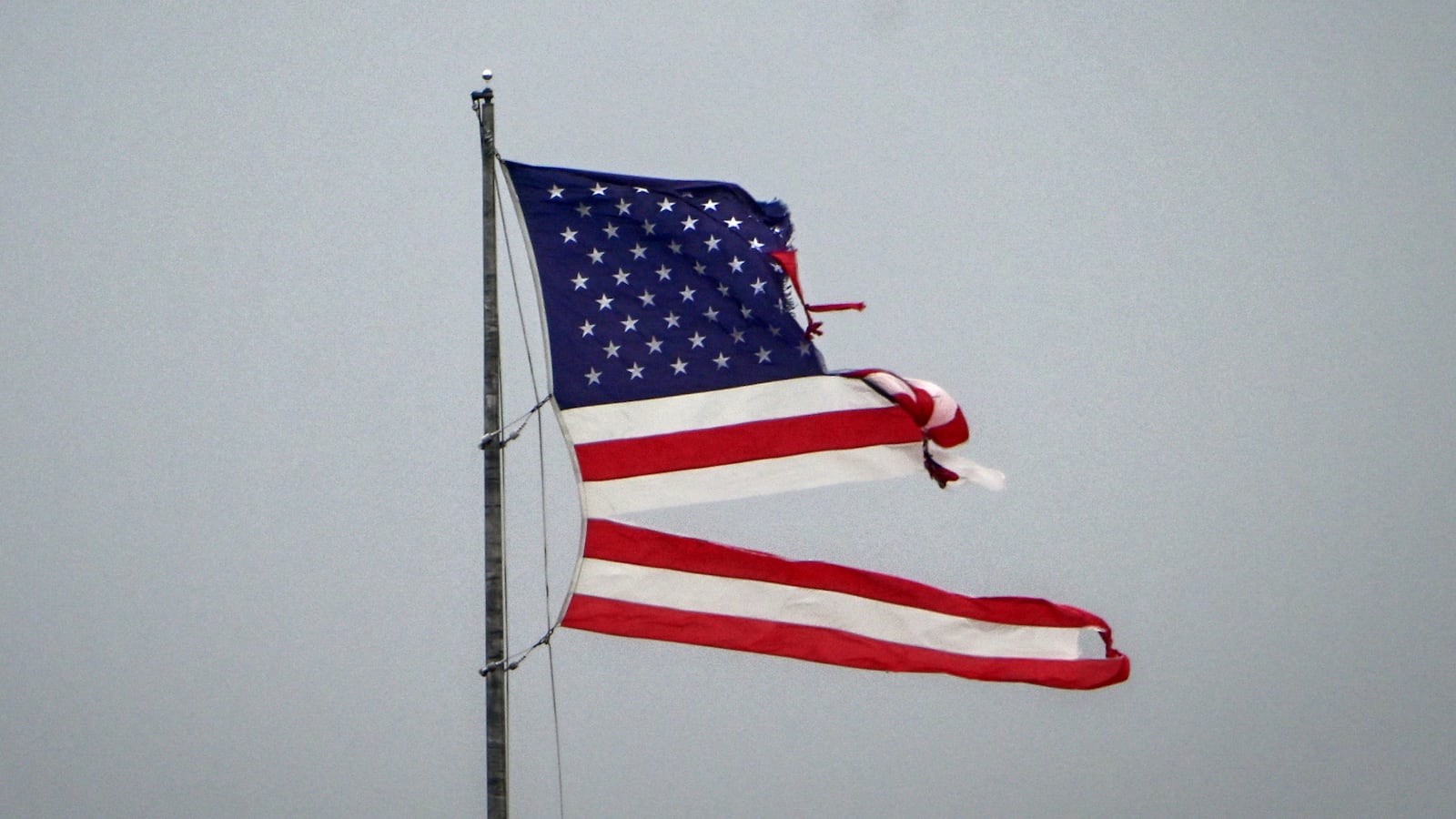 An American flag flies, destroyed by the intense tornado that hit Cocoa Beach, Florida on October 10, 2024. Hurricane Milton tore a coast-to-coast path of destruction across the US state of Florida, whipping up a spate of deadly tornadoes that left at least four people dead, but avoiding the catastrophic devastation officials had feared. (Photo by Giorgio VIERA / AFP) (Photo by GIORGIO VIERA/AFP via Getty Images)