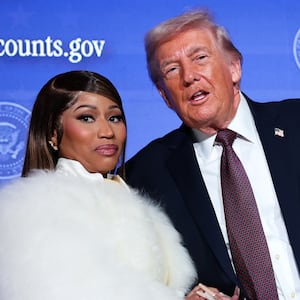 WASHINGTON, DC - JANUARY 28: Musician Nicki Minaj (L) joins U.S. President Donald Trump on stage as he delivers remarks during the Treasury Department's Trump Accounts Summit at Andrew W. Mellon Auditorium on January 28, 2026 in Washington, DC. "Trump Accounts" are a portion of recently passed tax and spending legislation where the federal government will deposit $1,000 into investment accounts for every child born between 2025 and 2028 once parents sign their children up while filing their income taxes.  (Photo by Win McNamee/Getty Images)