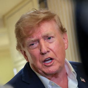 U.S. President Donald Trump speaks to members of the media aboard Air Force One, en route to Joint Base Andrews, Maryland, U.S., following a two-day visit to Ireland, September 13, 2026.