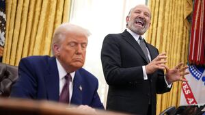 Secretary of Commerce Howard Lutnick (R) speaks alongside U.S. President Donald Trump in the Oval Office at the White House on February 13, 2025 in Washington, DC.