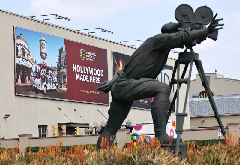BURBANK, CALIFORNIA - SEPTEMBER 12: "The Cameraman" statue, sculpted by Aldo and Andrea Favilli, stands outside Warner Bros. Studio on September 12, 2025 in Burbank, California. Media giant Paramount Skydance is reportedly preparing a bid to purchase Warner Bros. Discovery, including its movie studio and cable networks