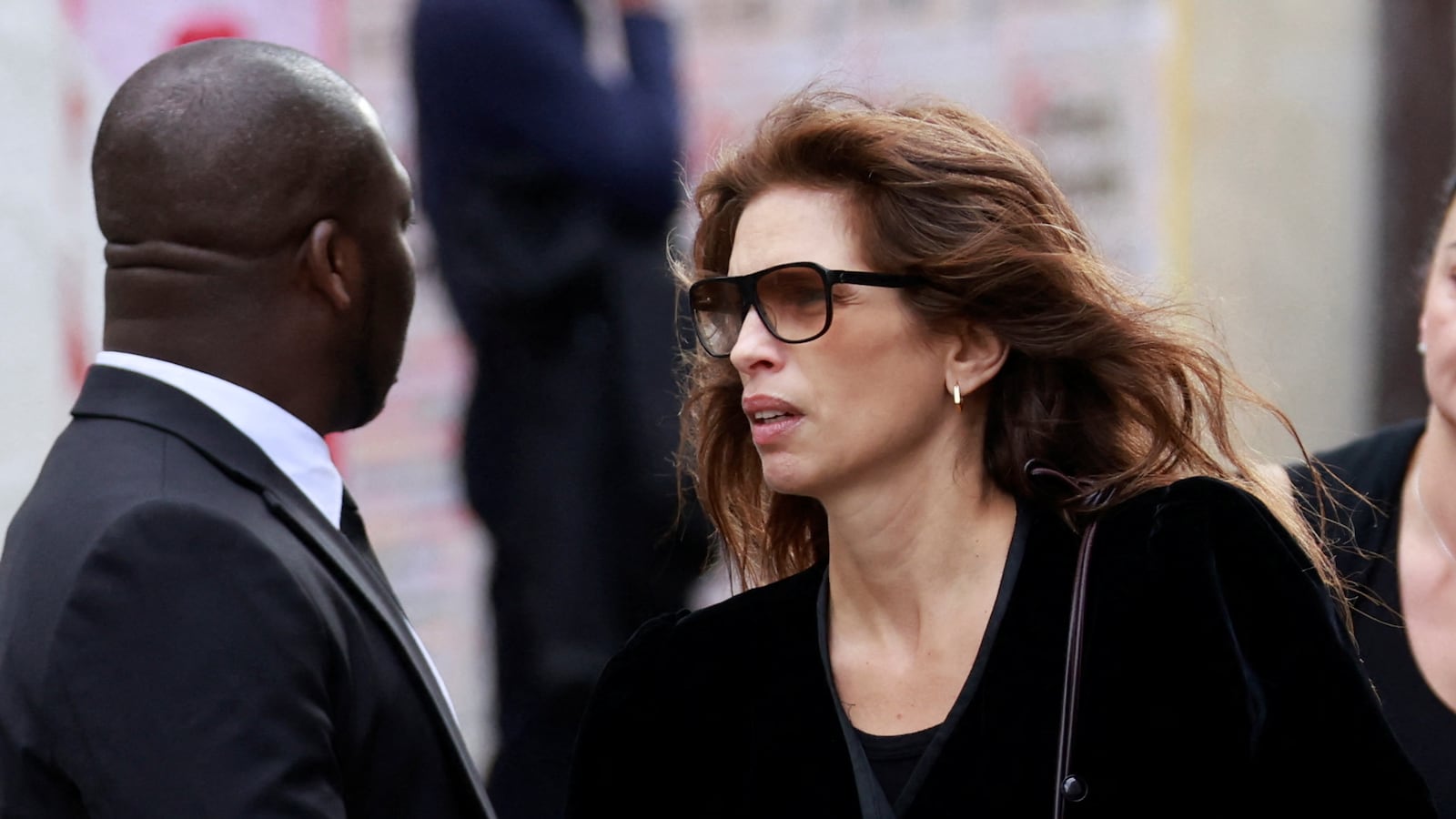 Maïwenn walks in all black as she attends a funeral.