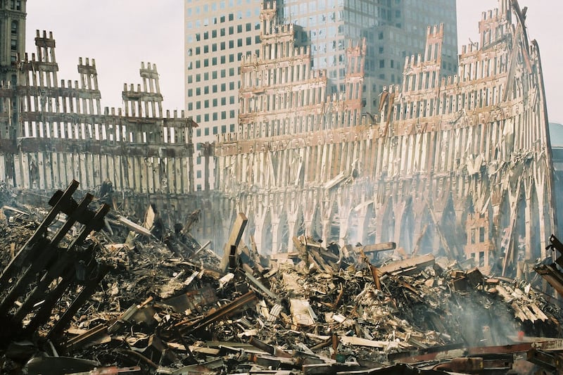 The remaining section of the World Trade Center is surrounded  by a mountain of rubble following on September 27, 2001