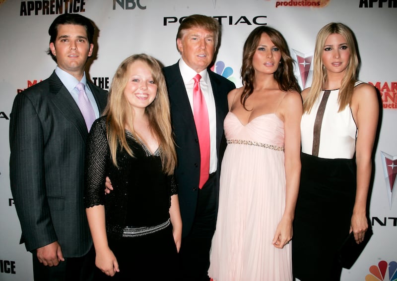 Donald Trump (C), entrepreneur and host of the television reality series "The Apprentice", poses with his wife and children Donald Trump Jr.(L), Tiffany Trump (2nd L), Melania (2nd R) and daughter Ivanka at the party following the live telecast of the finale of season five in Los Angeles, California June 5, 2006.