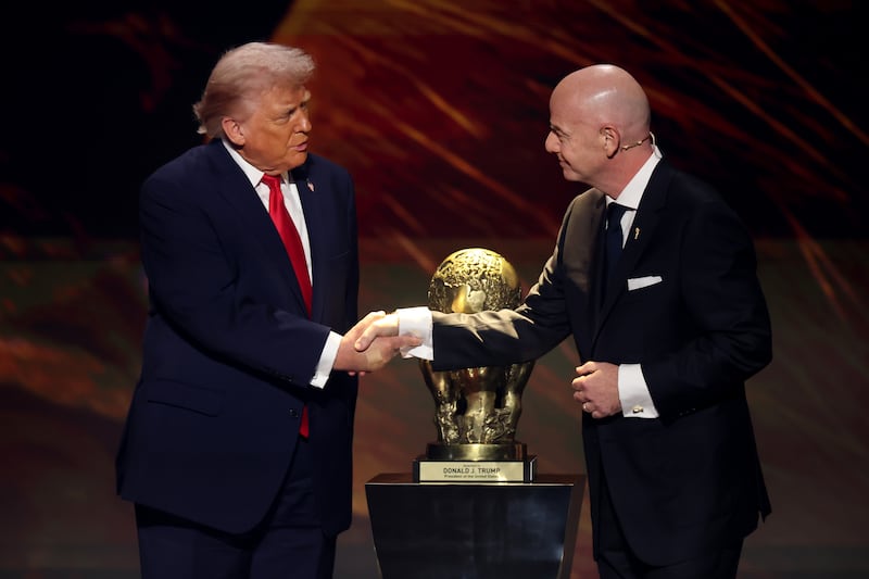 FIFA President Gianni Infantino shakes hands with President Donald Trump as he receives the inaugural FIFA Peace Prize during the FIFA World Cup 2026 Official Draw at John F. Kennedy Center for the Performing Arts on December 05, 2025.