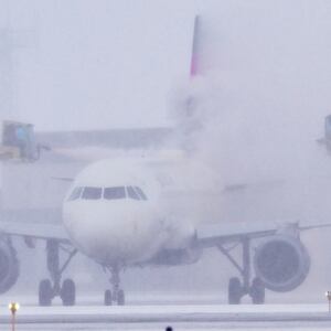 A Delta Air Lines jet is de-iced at Minneapolis-St. Paul International Airport.
