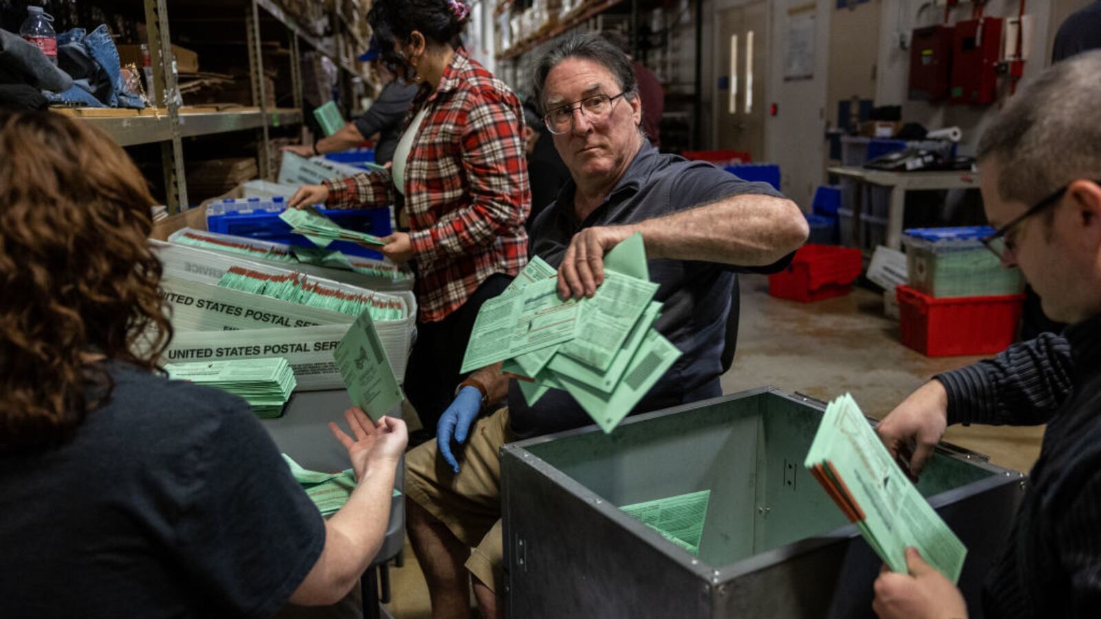 Election workers sort envelopes of ballots at the Maricopa County Tabulation and Election Center on November 08, 2022.