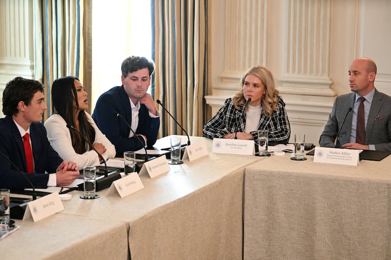 Journalist Savanah Hernandez (2nd L) speaks next to Nick Shirley (L), Cam Higby (3rd L), Press Secretary Karoline Leavitt (2nd R) and Deputy White House Chief of Staff Stephen Miller (R) during a roundtable about Antifa in the State Dining Room of the White House in Washington, DC, on October 8, 2025. (Photo by Jim WATSON / AFP) (Photo by JIM WATSON/AFP via Getty Images)