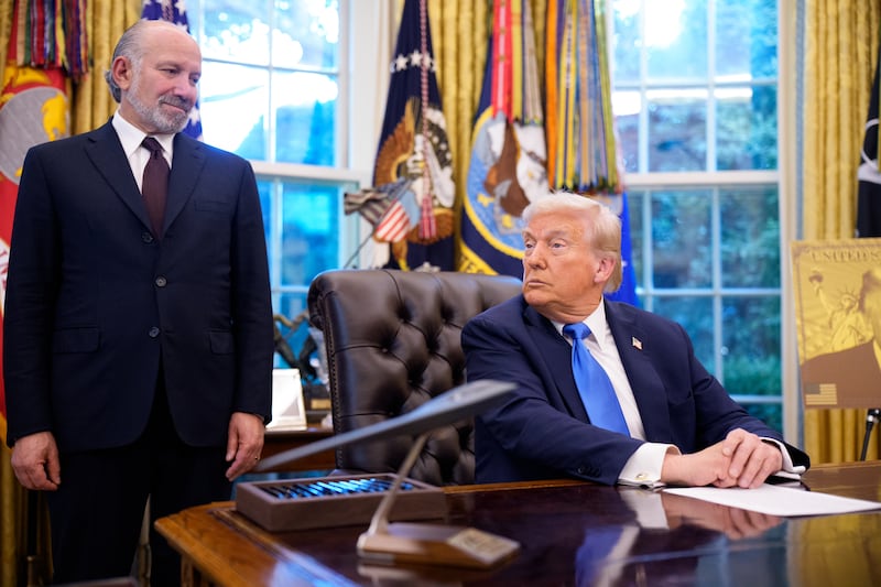 President Donald Trump, accompanied by U.S. Commerce Secretary Howard Lutnick
