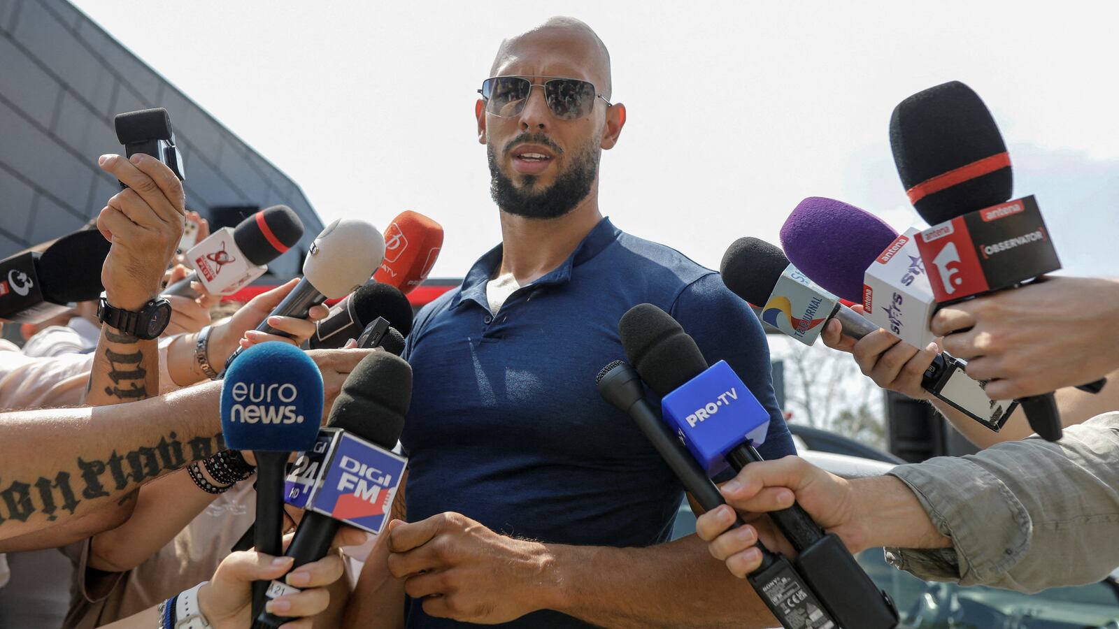 Andrew Tate delivers a press statement outside his house in Romania.