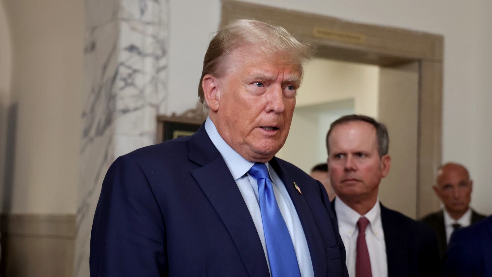 Donald Trump speaks to reporters outside of a Manhattan courtroom.