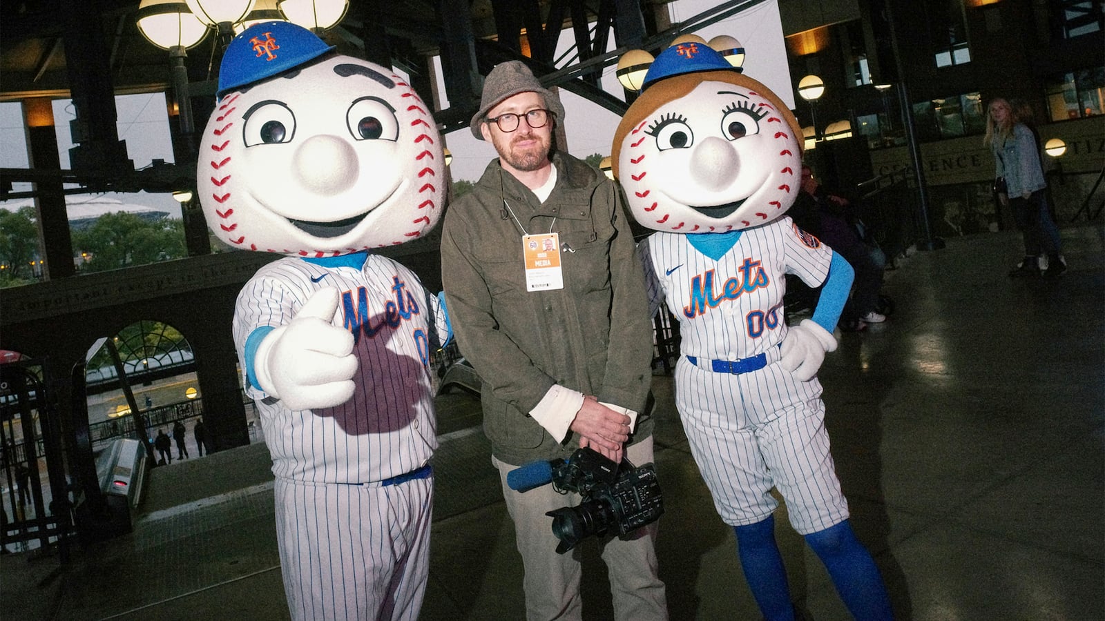 John Wilson poses with Mr and Mrs Met at Mets Stadium.